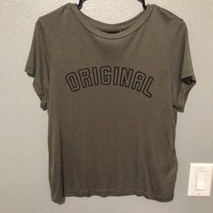 Green t-shirt with “Original” printed on it